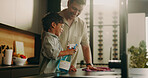 Dad, kid and spray for cleaning, learning and teaching domestic duties with parenting in home. Hygiene, disinfect and man guiding son with detergent, wiping counter or help with kitchen cleanliness