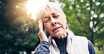 Senior, woman and fitness with headache in park for outdoor strain, fatigue or mental health. Active, elderly or female person with sore head, migraine or lens flare in nature for workout or pressure