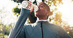 Fitness, woman or drinking water at park for wellness, health lifestyle or workout rest for recovery. Thirsty runner, black person or hydration break with bottle outdoor, electrolytes or cool down