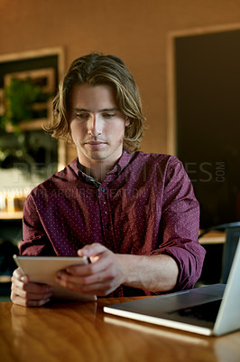 Buy stock photo Creative, employee and man with tablet, cafe and remote work for digital magazine, typing or online. Editing, article and journalist with tech for freelance project, laptop and story in coffee shop