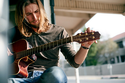 Buy stock photo Playing, music and man with guitar outdoor with tuning instrument, performance or practice. Artist, rehearsal and male person with acoustic strings for song with creative talent, hobby or activity.
