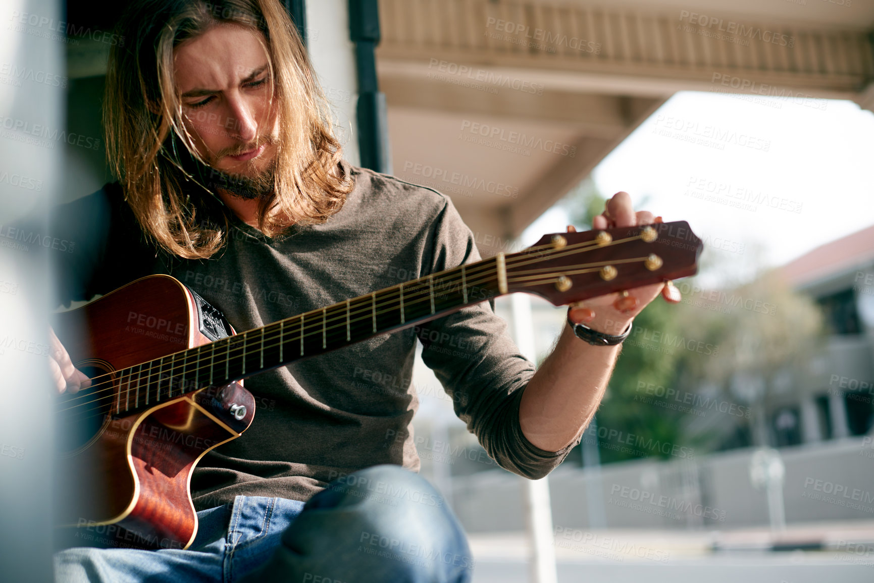 Buy stock photo Playing, music and man with guitar outdoor with tuning instrument, performance or practice. Artist, rehearsal and male person with acoustic strings for song with creative talent, hobby or activity.
