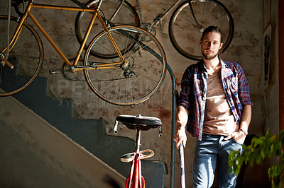 Buy stock photo Portrait, garage and man with startup, bike repair and maintenance with skills, pride and mechanic. Person, bicycle and business owner with restoration expert, industry and confidence with service