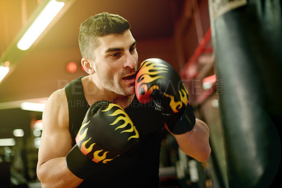 Buy stock photo Boxing bag, workout and man in gym for training, challenge or cardio activity for practice. Fitness, intense power and athlete with punching equipment for performance or exercise in sports center