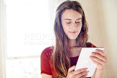 Buy stock photo Happy girl, relax and reading with tablet for blog, online app or ebook story at home. Female person, user or teenager browsing with technology or UI for network, connection or social media research