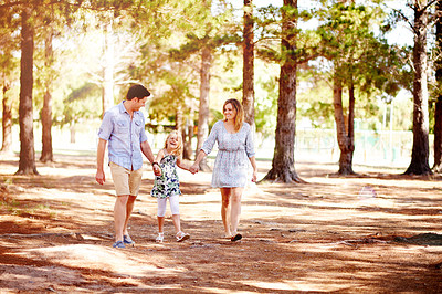 Buy stock photo Parents, child walking and holding hands at park for holiday, family vacation and laugh together. Mother, father and funny kid in nature for happiness, support and travel with girl on journey
