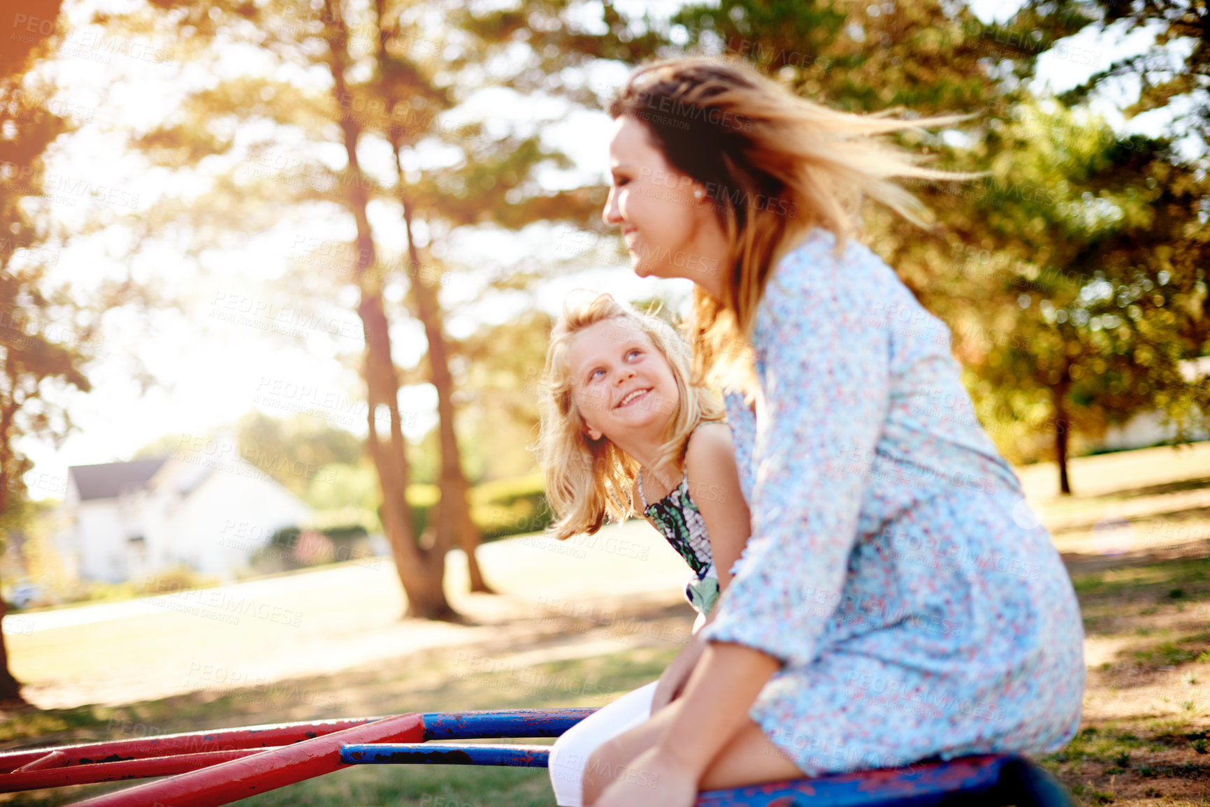 Buy stock photo Smile, mother and child on carousel at playground for holiday fun, play games and bonding together. Happy, family and kid on merry go round for spinning ride, activity and balance support on vacation