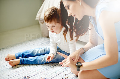 Buy stock photo Child, mother and help with puzzle at house for learning, problem solving skills and connect pieces. Kid, woman and jigsaw games for education, creative activity and bonding for cognitive development