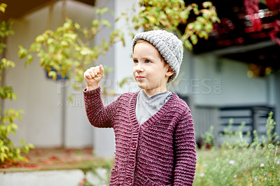 Buy stock photo Thinking, child and calm in backyard, outdoor or playing with plants on weekend, confident and home. Reflection, kid and boy with winter clothes, game and nature for sensory growth and development