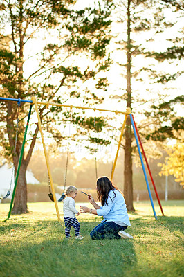 Buy stock photo Happy, playing and mom with child, playground and bonding with daughter on weekend, love or outdoor. Park, woman and smile with toddler in nature, growth and development of girl, family and childcare
