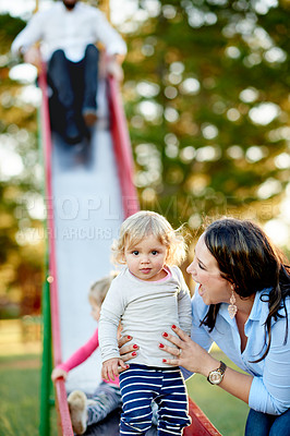 Buy stock photo Playground, happy and mom with child on slide for outdoor adventure, playing and having fun together. Family, portrait and mother with kids at park for bonding, holiday and relationship in nature
