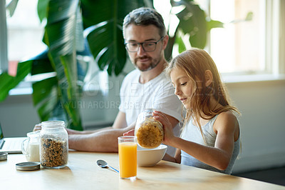 Buy stock photo Breakfast, hungry or morning with father and daughter in dining room of home together for meal. Cereal, eating or juice with girl child and single parent man in apartment for bonding on weekend