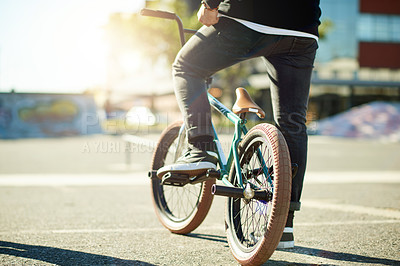 Buy stock photo Bicycle, legs and person for outdoor hobby, activity or challenge in urban skate park. Bike, shoes and feet for cycling, BMX training and skills for competition in city for balance and stunt exercise