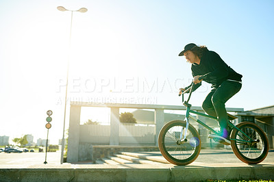 Buy stock photo BMX, man and bicycle in city for sports, urban challenge and exercise with space. Person, riding bike and cyclist on curb outdoor for fitness, extreme cycling and balance for stunt with flare