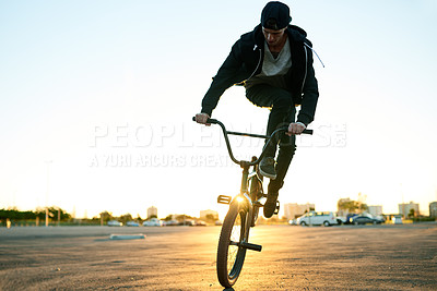 Buy stock photo Athlete, man and jump with bicycle in city for travel, tricks training and cardio exercise. Person, cycling and bike for fitness activity, sports workout and sustainable transport for stunt practice
