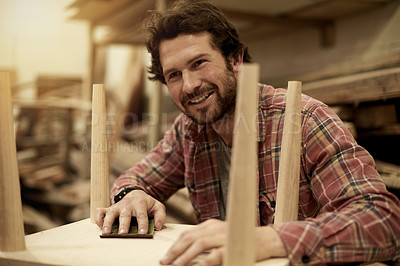 Buy stock photo Carpenter, workshop and man with smile for sanding furniture, manufacturing and lumber production. Artisan, craftsmanship and carpentry with tools for planks, timber and building or restoration