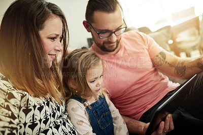 Buy stock photo Happy, family and child in home with tablet for streaming cartoon, kids movie and bonding together. Smile, parents or daughter in apartment with digital app, watching video or online entertainment.