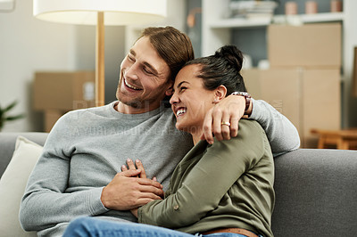 Buy stock photo Couch, moving and happy couple hug in new home for love, property investment or mortgage. Real estate, man and woman embrace in living room for relax, relocation or laugh with partner in dream house