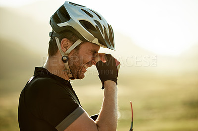 Buy stock photo Man, cycling and allergies with headache, pain and nasal congestion with pollen in countryside. Person, profile and inflammation with helmet for eye strain, space or triathlon training in Germany