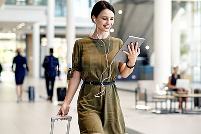 Buy stock photo Happy, tablet and businesswoman in airport with suitcase for online meeting or contact. Digital technology, earphones and female employee on virtual discussion with luggage for global work trip.