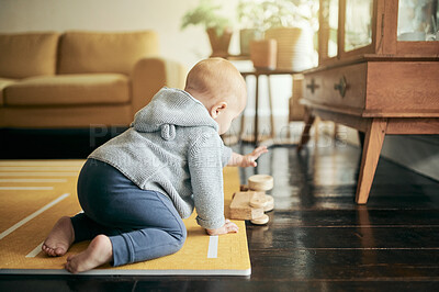 Buy stock photo Baby, toy car and play in home, having fun and learning or relaxing in living room. Development, childhood and cute kid, newborn and toddler playing with wooden truck and toys on floor in house.
