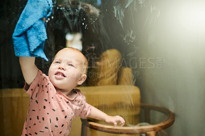 Buy stock photo Kid, washing and cleaning window in home for hygiene, health or wellness. Chores, child and toddler, infant or baby clean glass with cloth and soap for helping to remove bacteria to sanitize house.