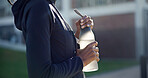Woman, hands and fitness with water bottle in city for outdoor workout break, hydration or recovery. Active, female person or rest with mineral liquid for sustainability, vitamins or nutrition