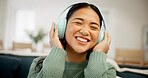 Headphones, music or asian woman listening in home for audio streaming or entertainment app. Happy, female person or subscription with smile, sound or network connection for weekend podcast in house