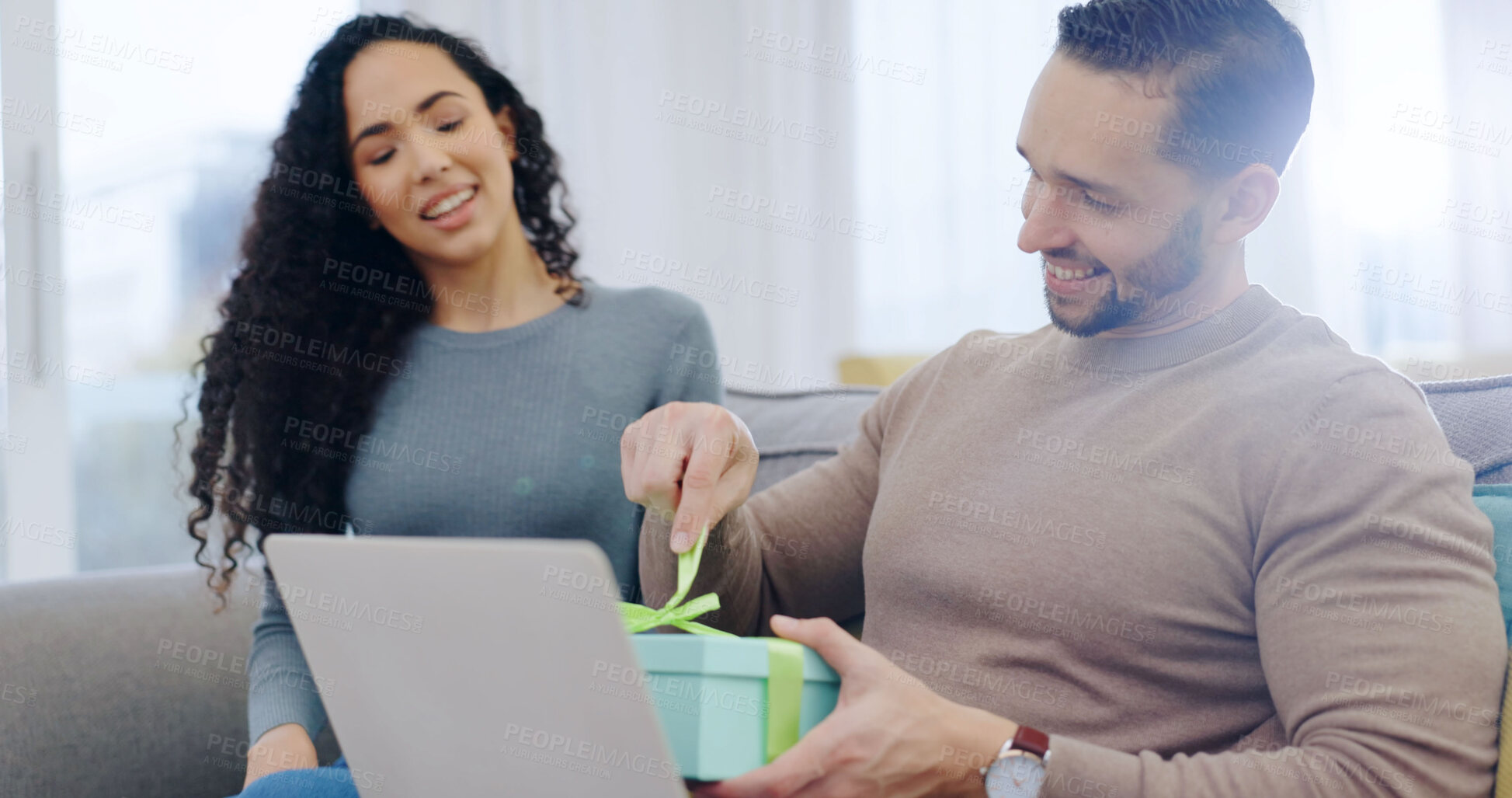 Buy stock photo Couple, love or unboxing gift in home with smile for birthday celebration, care or appreciation. Open present, man or happy woman on sofa for surprise, gratitude or bonding on special day with laptop