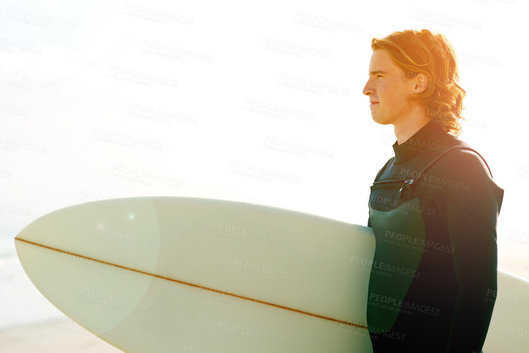 Buy stock photo Surfboard, fitness and man by beach for exercise, training or holiday activity for wellness. Sunset, swimsuit and male athlete by ocean for surfing, flare or water sports on tropical vacation.