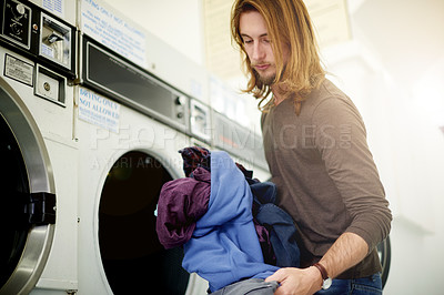 Buy stock photo Laundry, cleaning and man at laundromat with clothes for chores, hygiene or maintenance. Washing, machine and male person with material or fabric with housework at store for housekeeping duty.