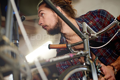 Buy stock photo Mechanic, bicycle or man with wheel inspection in workshop for tyre puncture, repair or fix damage. Bike technician, person and rim alignment in garage for ride performance, service or cycling safety
