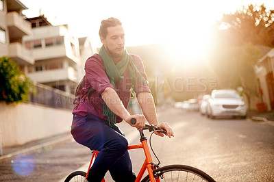 Buy stock photo Travel, sunset and man on bicycle in city for commuting, journey or carbon footprint on adventure. Street, cycling and person on bike for eco friendly transport on vacation, weekend trip or holiday.