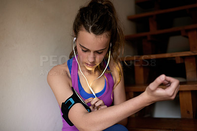 Buy stock photo Fitness, girl and phone in home with music, song selection and update training app. Teenager, earphones and mobile in house to arrange playlist, workout podcast and ready for exercise with technology