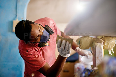 Buy stock photo Mask, workshop and black man with surfboard, polish and creative for talent and hobby skills. Craftsman, artist and sponge with PPE gloves for design, manufacturing and custom work for artisan craft