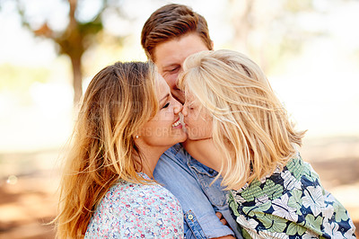 Buy stock photo Kiss, nature and parents with kid in park for bonding, care and family time on holiday. Smile, love and girl child with mom and dad for playing together outdoor in garden on weekend in countryside.