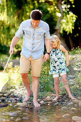 Buy stock photo Nature, travel and child with dad, net and adventure for holiday or curiosity. Forest, entomology and girl with father, pond and conservation or vacation and rocks in woods with learning or explore