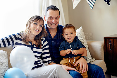 Buy stock photo Family, portrait and birthday with parents and toddler in living room for celebration, love and milestone at home. Happiness, together and man with woman and child for party or event with decorations