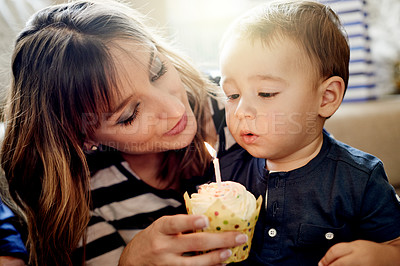 Buy stock photo Birthday, candle or celebration with mom and son on sofa in living room of home for milestone. Cupcake, growth or party with boy child and parent woman in apartment for bonding as family in house