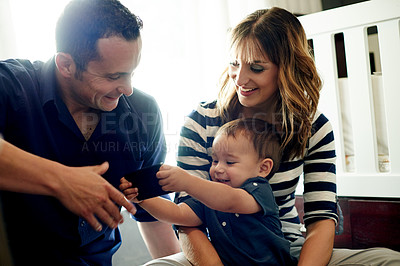 Buy stock photo Parents, happy or toddler playing with phone in family house for funny joke or bonding together. Laughing, father or mom with child in home for relationship, growth development or support with mobile