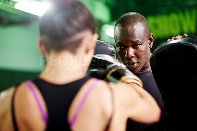 Buy stock photo Boxing, pads and sports with personal trainer man in gym for fitness or sparring session. Exercise, training or workout with boxer and coach in health club for improvement of skill or technique