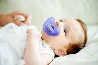 Buy stock photo Relax, calm or infant with pacifier on bed for self soothing, provide comfort or sleeping help. Rest, emotion regulation or baby girl with dummy in home for nap time, child reflex or distraction