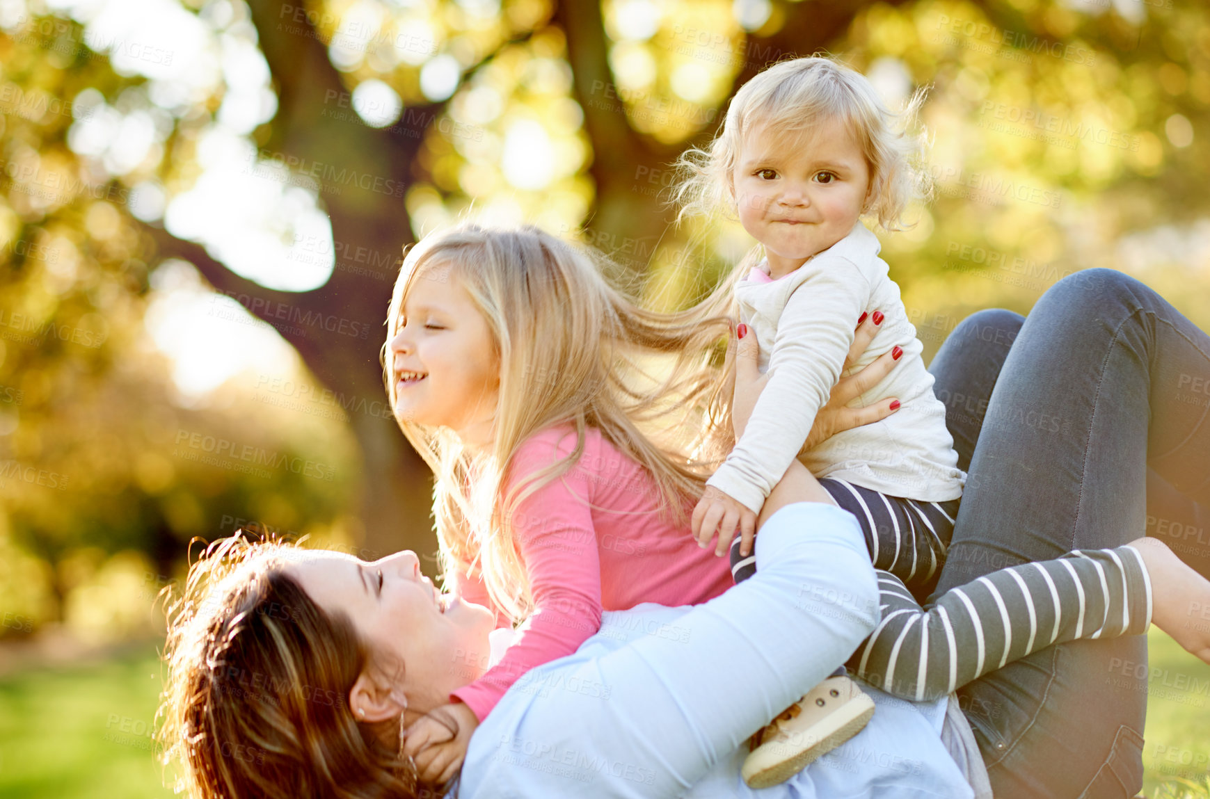 Buy stock photo Bonding, children and woman in nature, laugh and playing on summer holiday, fun and game on weekend. Lifting, daughter or happy mom with kids on break, relax and family at park, bokeh and together