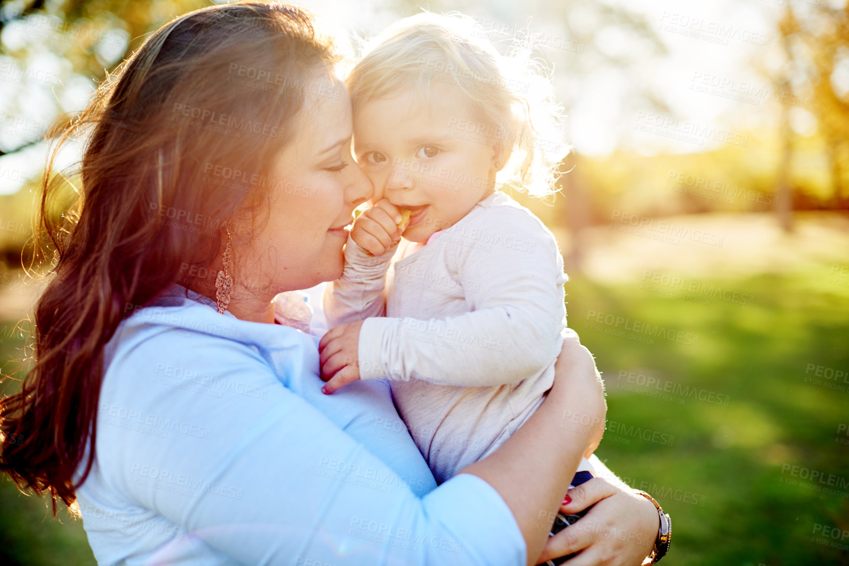 Buy stock photo Love, mother and hug child at park for safety, security and kid eating food on vacation. Nature, mom and carry toddler with embrace for connection, care and support with portrait for family holiday