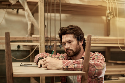 Buy stock photo Carpenter, drawing and man in workshop for furniture, manufacturing and lumber production. Artisan, craftsmanship and carpentry with tools for planks, timber and woodwork building or restoration