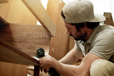 Buy stock photo Man, carpenter and fixing wood with tools for manufacturing furniture, repairs and woodwork maintenance. Male person, drill and wardrobe with diy renovation, production and hobby for home improvement