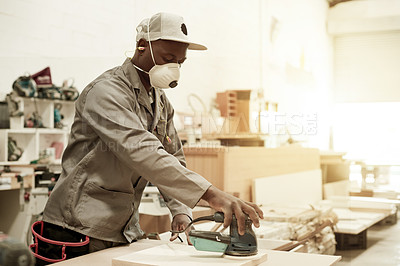 Buy stock photo Carpenter, mask or black man in workshop with sander, orbital or repair for renovation. Person, worker or craft on surface with power tool, maintenance or project in construction warehouse.
