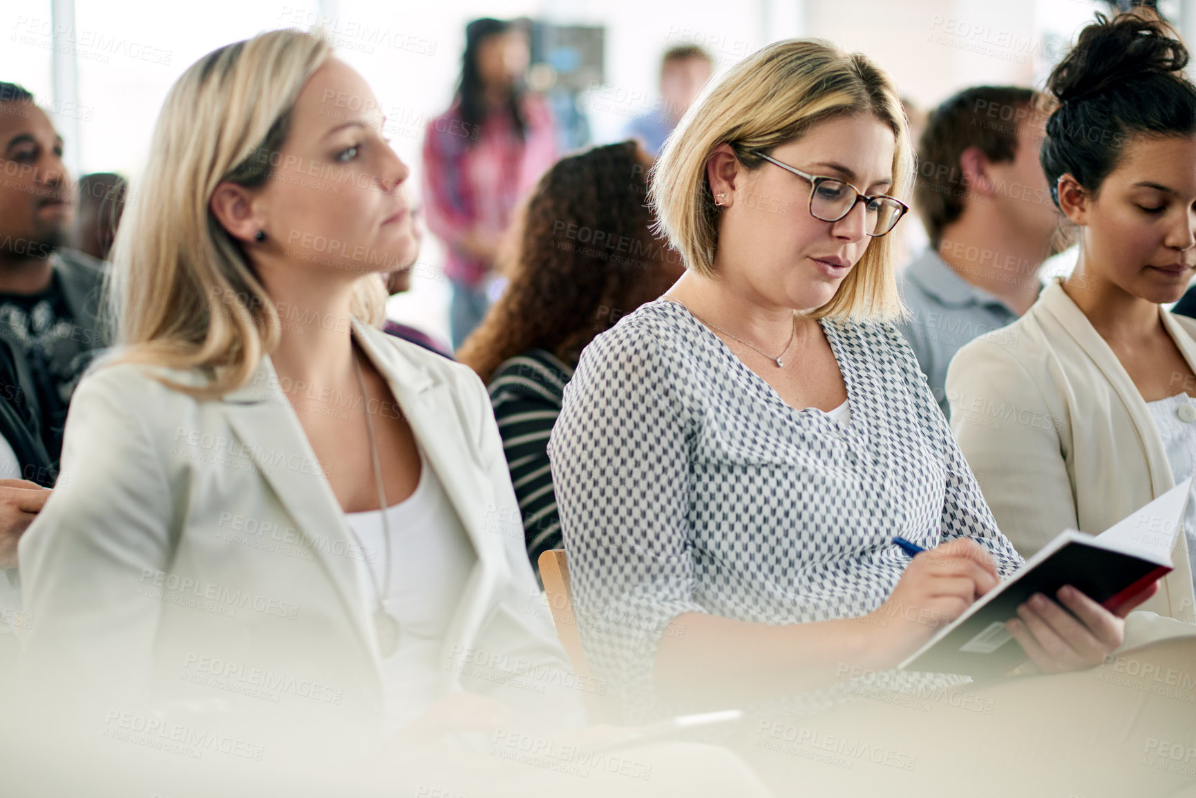 Buy stock photo Business, woman and writing notes in workshop for training, career development and schedule update. Person, employees and notebook for corporate convention, learning session and forum for tradeshow