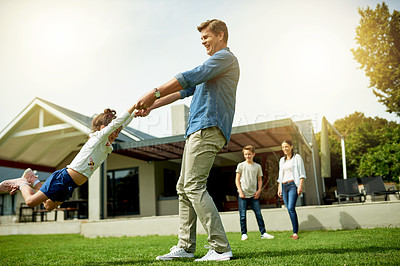 Buy stock photo Outdoor, family and father swinging child in home garden for bonding, connection and fun together. Happy, love and dad spinning and playing with girl kid on weekend in backyard of house in summer.