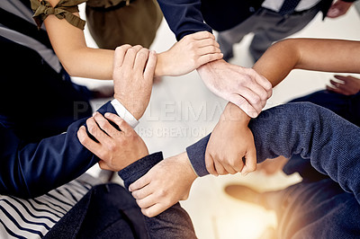 Buy stock photo Top view, holding arms and business people with teamwork in office for solidarity or community. Above, link connection and employees with hands together for collaboration, support or company growth